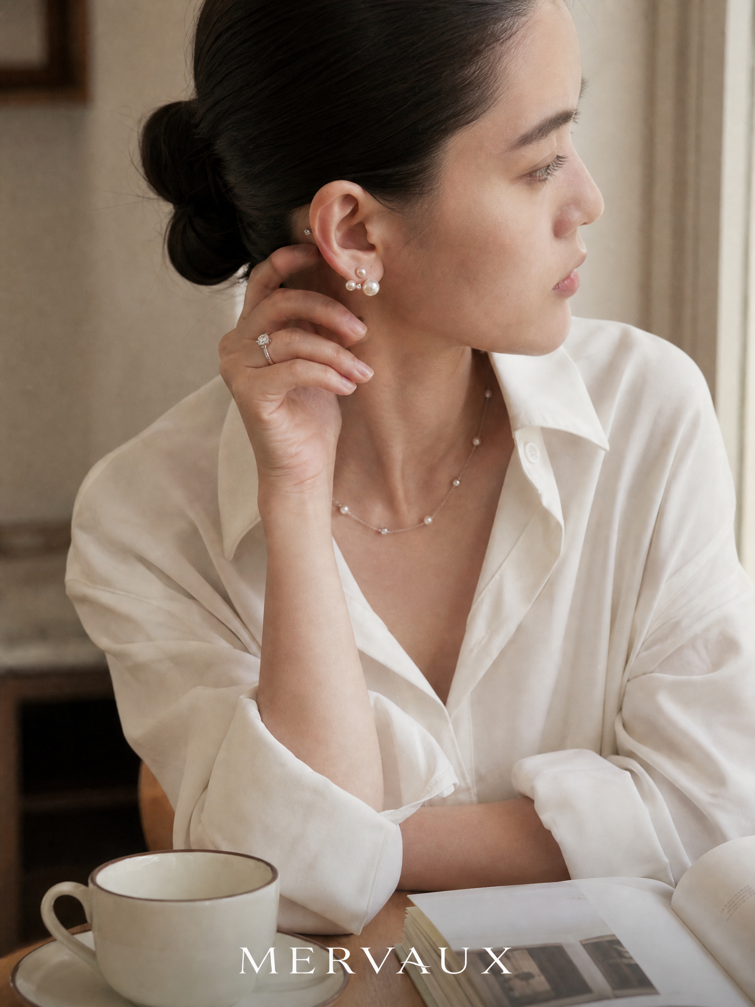 A platinum ring worn at a cafe table, in the middle of an ordinary day rather than an occasion.