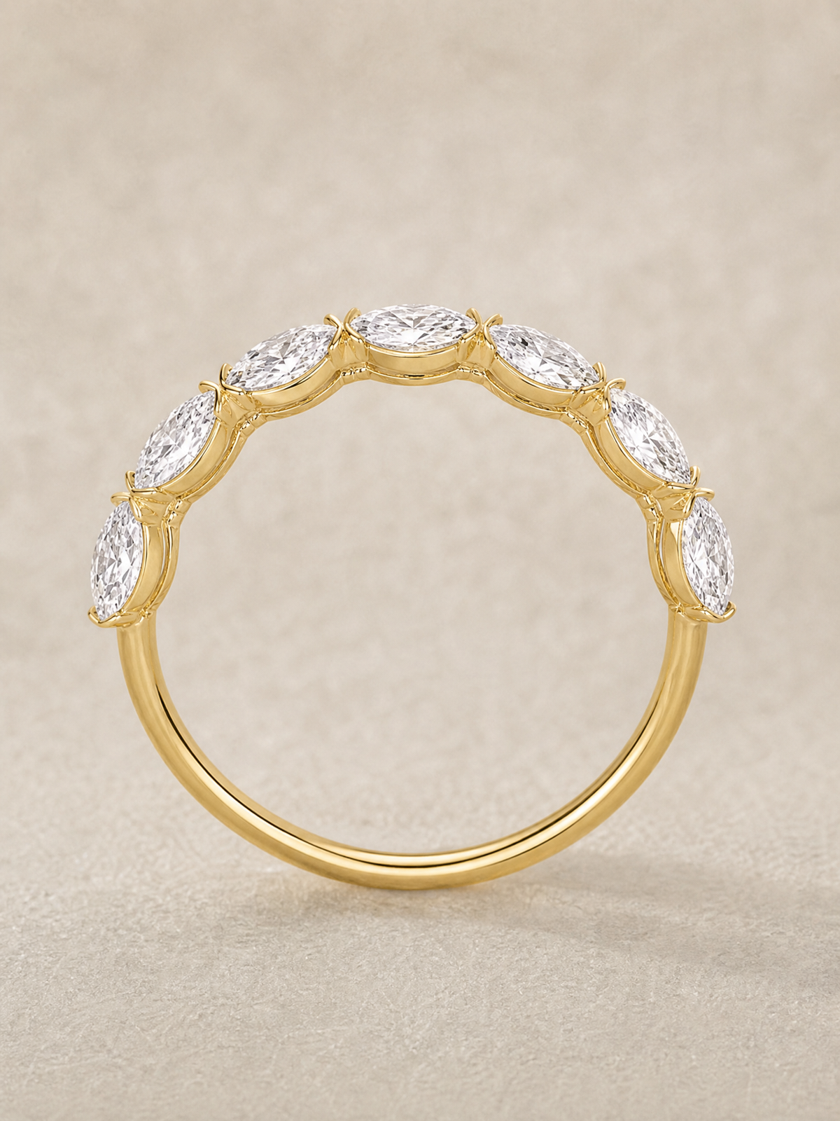 A marquise diamond band in solid 14K yellow gold, the karat most often chosen for a ring worn every day.