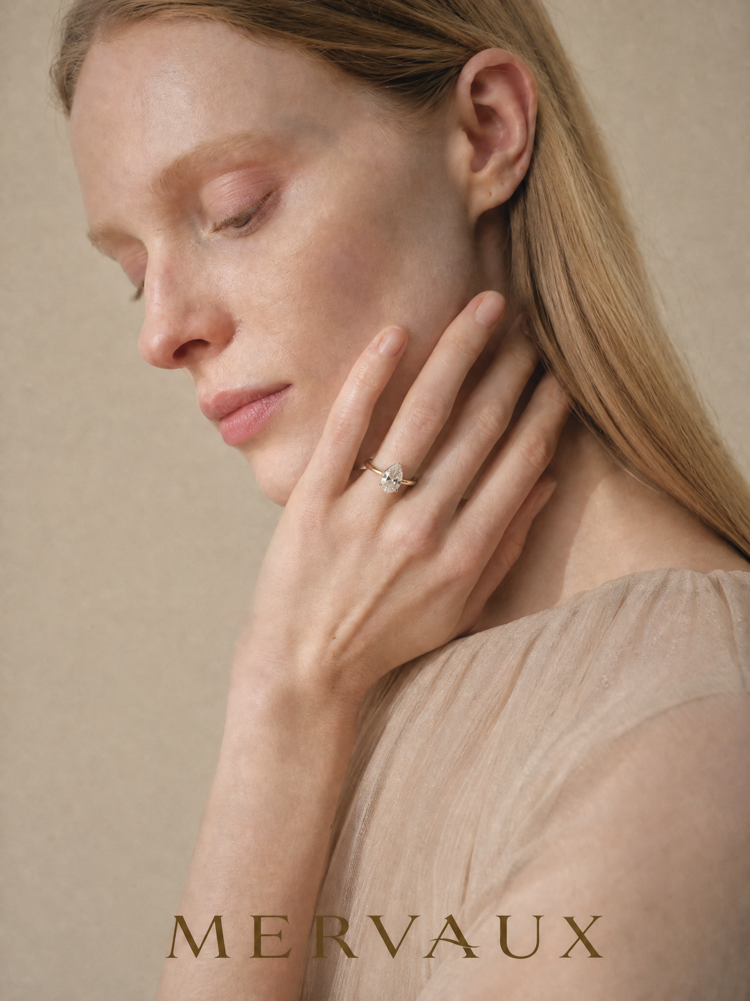 MERVAUX two-tone pear diamond ring worn, hand at neck