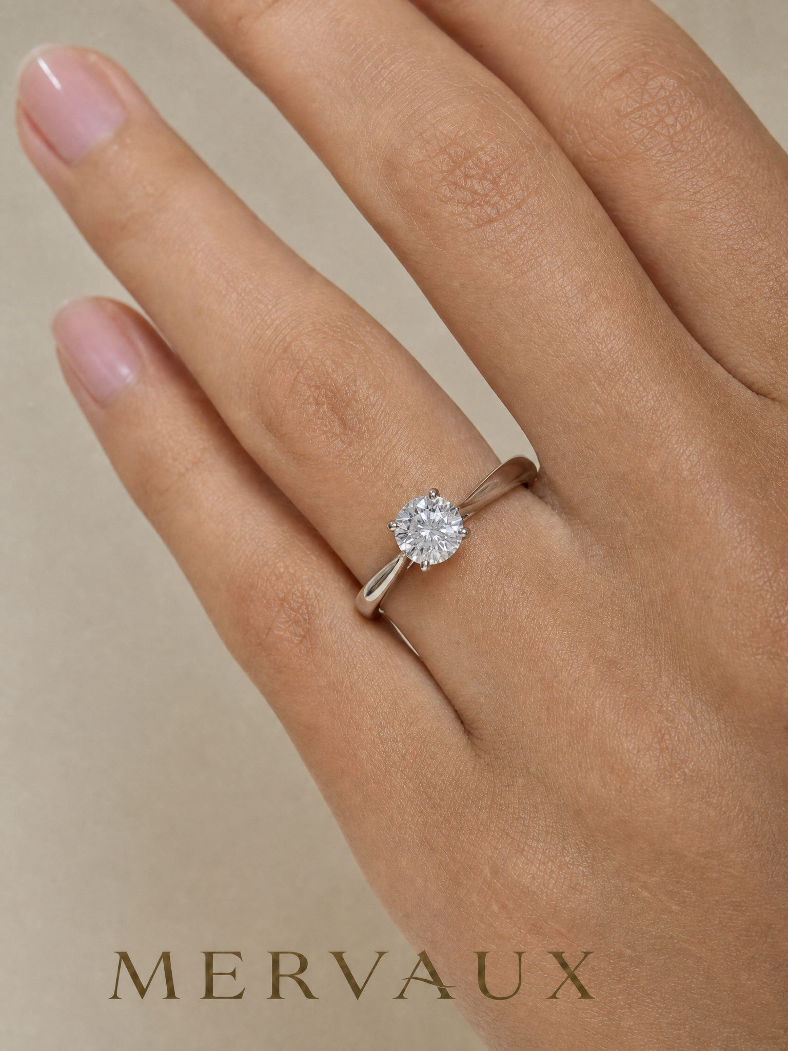 MERVAUX platinum round brilliant solitaire worn on hand, true to scale