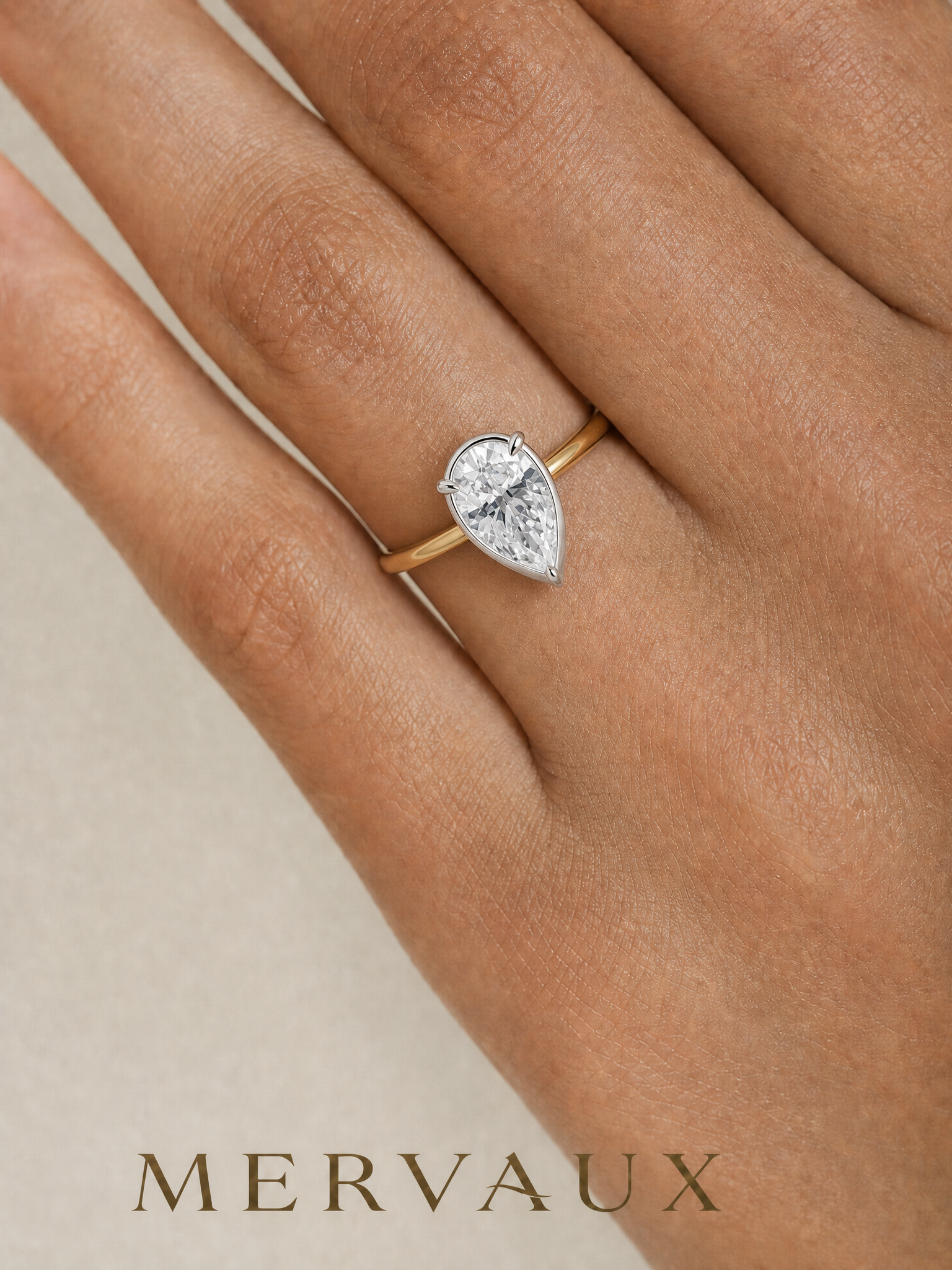 MERVAUX two-tone pear diamond ring worn on hand, true to scale