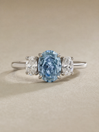 MERVAUX 3.04 ct fancy intense blue oval three-stone diamond ring in white gold - front view