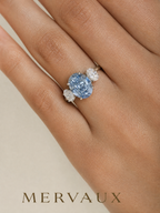 MERVAUX blue oval three-stone diamond ring worn on hand, true to scale