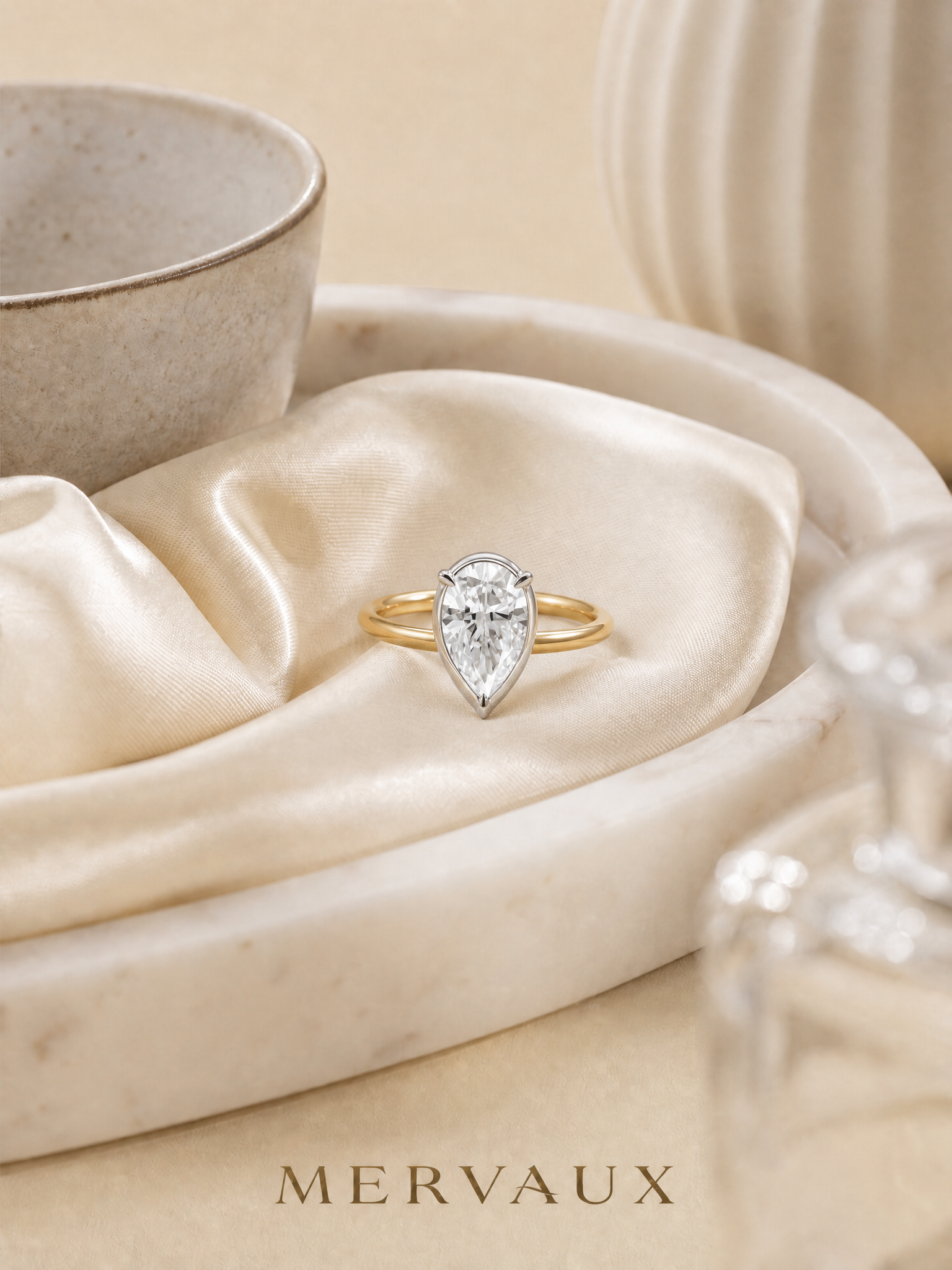 MERVAUX two-tone pear diamond ring, still life on satin